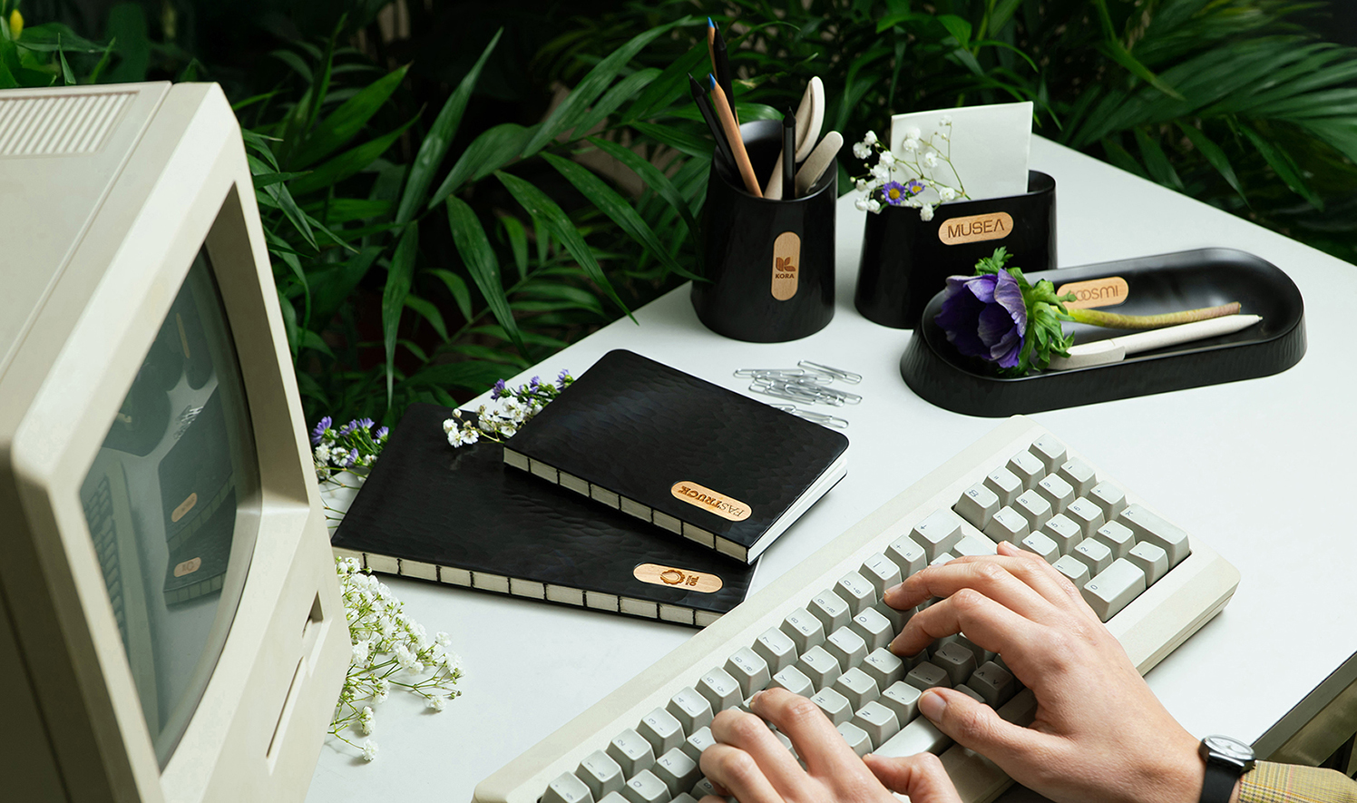 Customized TREEPLASTIC sustainable promotional gadgets on a desk.