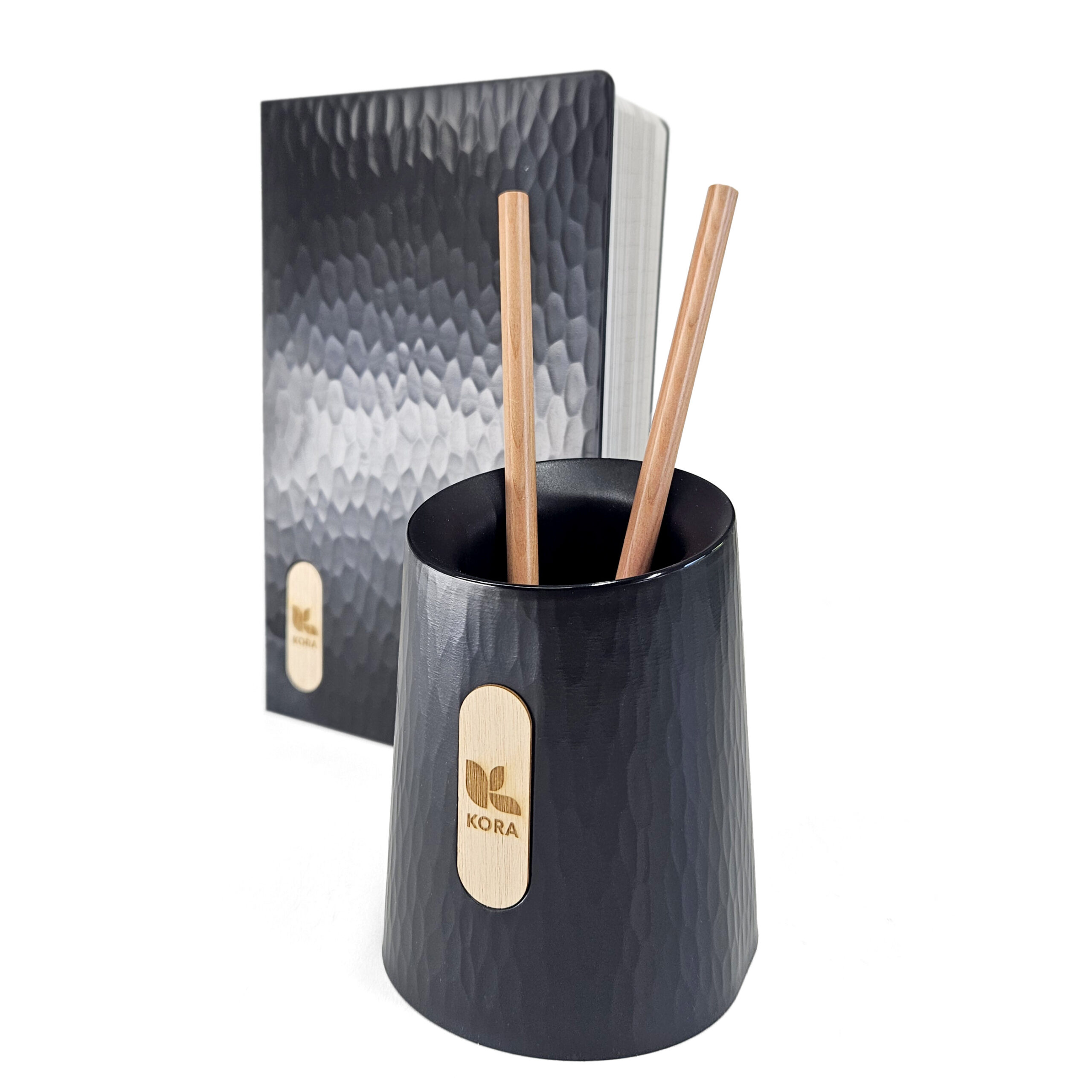 Treeplastic pen holder and notebook made from recycled wood.